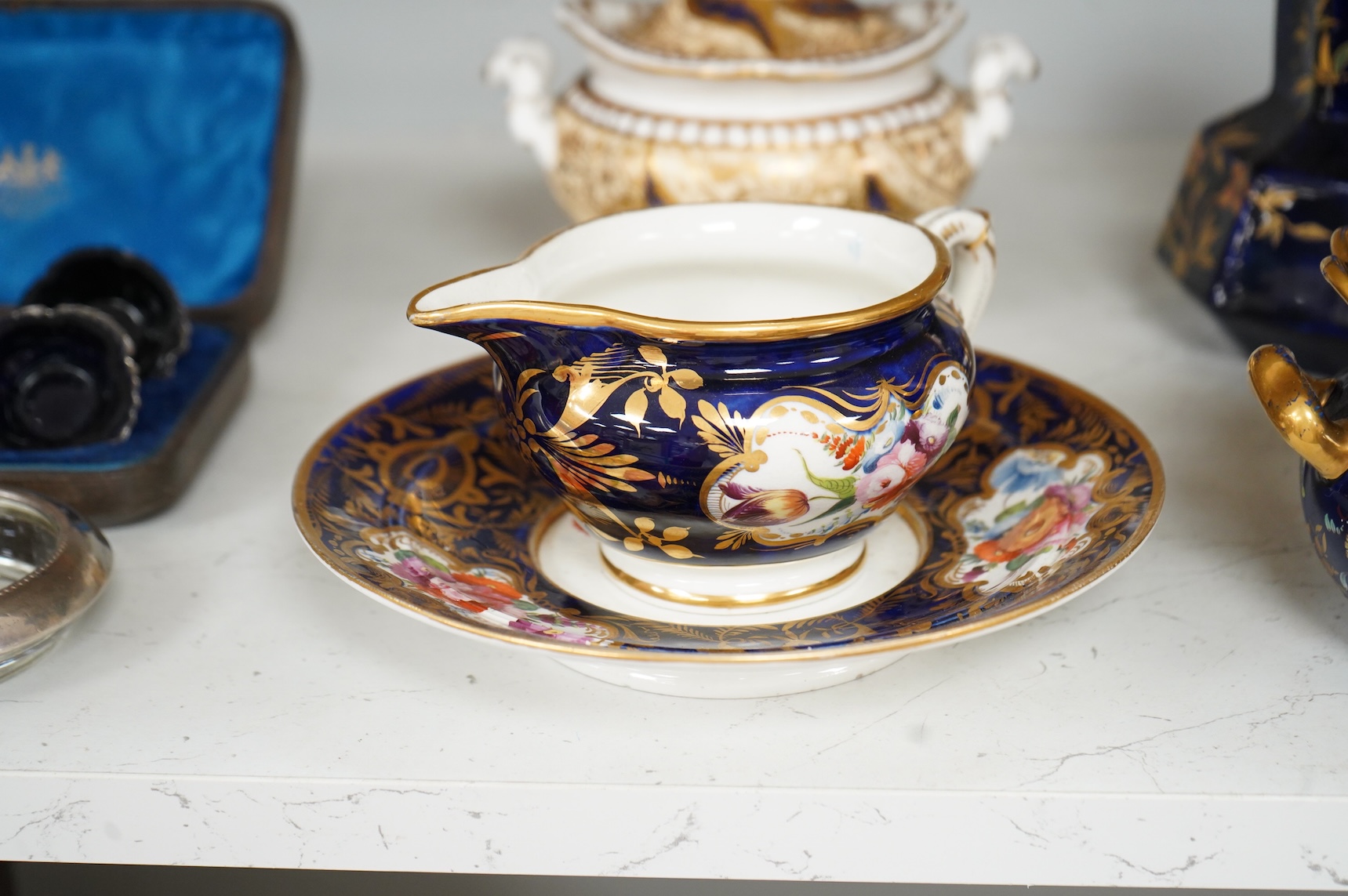 A Group of early 19th century English porcelain; to sauce tureens and covers, one with stand, a covered sugar bowl, a two handled vase, a pot pourri vase and cover, a milk jug and a hydra shaped jug, largest 16cm high